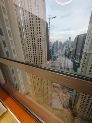 a view of a city skyline from a window at 2 Massage Chairs Marina View 2 Bedrooms in Dubai