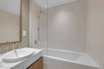 a bathroom with a tub and a sink and a shower at Gym, Spa & Sauna, Pool, Tenis Court, Dishwasher, 2BR in Central Park in Dubai