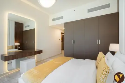 a bedroom with a large white bed and a mirror at Vogue JVC Jeewar Tower Near Circle Mall, One Bedroom Apartment with Balcony and City View, Access to all Amenities in Dubai