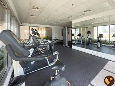 a gym with treadmills and exercise bikes in it at Vogue JVC Jeewar Tower Near Circle Mall, One Bedroom Apartment with Balcony and City View, Access to all Amenities in Dubai