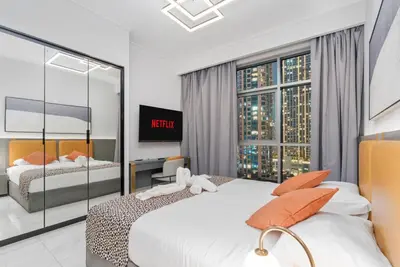 a bedroom with two beds and a window at Luxury 2BR Business Bay Balcony in Dubai