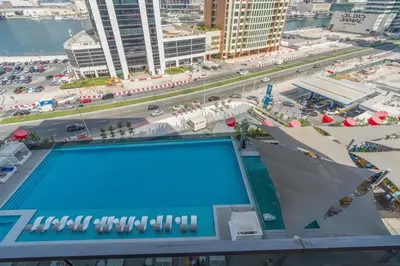 a view of a swimming pool on top of a building at Luxury 2BR Business Bay Balcony in Dubai