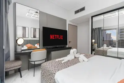 a hotel room with a bed with a tv on the wall at Luxury 2BR Business Bay Balcony in Dubai