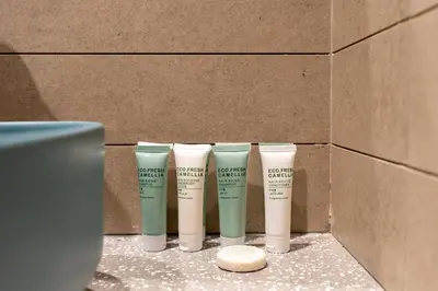 a group of four moisturizers in a cardboard box at Modern Studio Canal & Pool View Business Bay in Dubai