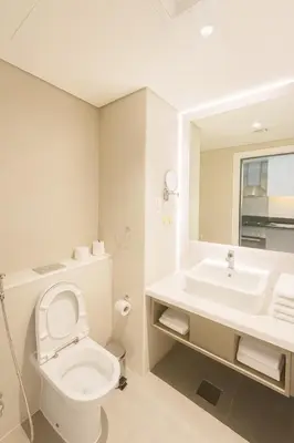 a white bathroom with a toilet and a sink at Opulent Suites - Business Bay - Downtown in Dubai