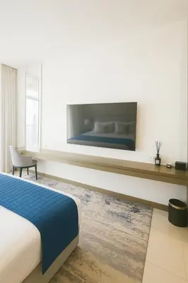 a hotel room with a bed and a large window at Opulent Suites - Business Bay - Downtown in Dubai