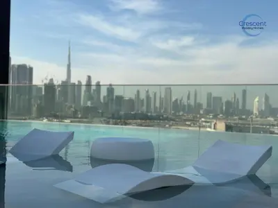 two white chairs sitting on top of a building at Premium 1 Bedroom Stay in Berkeley Place in Dubai