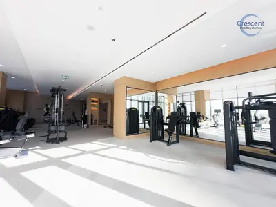 a gym with treadmills and machines in a building at Premium 1 Bedroom Stay in Berkeley Place in Dubai