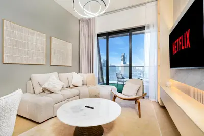 a living room with a couch and a table at Stylish 1BR Canal & Burj View High Floor in Dubai