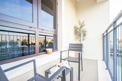 a balcony with two chairs and a window at Frank Porter - La Voile in Dubai