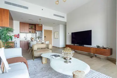a living room with a large flat screen tv at Frank Porter - La Voile in Dubai