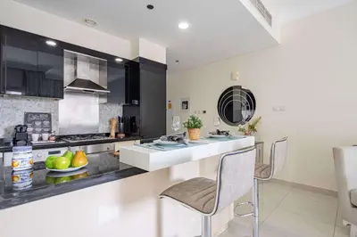 a kitchen with a counter with a sink and a stove at Frank Porter - The Signature in Dubai