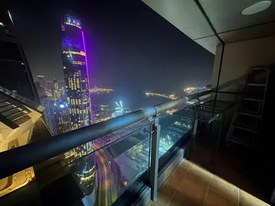 a view of a city at night with purple lights at Sea View Luxe Room Marina Dubai in Dubai