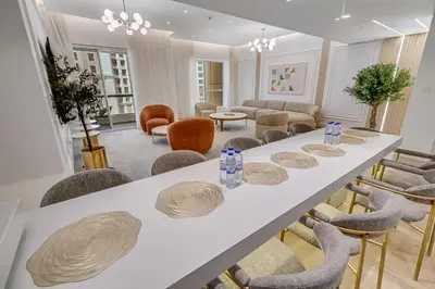 a large white table with chairs in a room at Sadaf 2701 in Dubai
