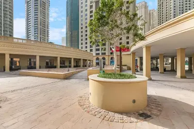 an empty courtyard in a city with tall buildings at Sadaf 2701 in Dubai