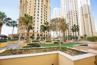 a park in the middle of a city with tall buildings at Sadaf 2701 in Dubai
