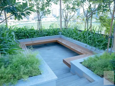 a garden with a bench in the middle at Elegant Haven by Meraki - New 1 Bed Garden View in Dubai