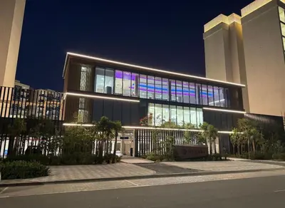 a large building with lights on the side of it at Elegant Haven by Meraki - New 1 Bed Garden View in Dubai