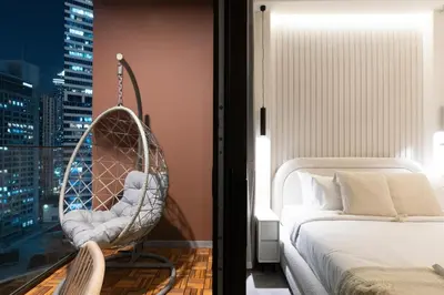 a swing in a bedroom with a bed and a city at 2 Apt Combo Studio And 1BR Same Tower Canal View in Dubai