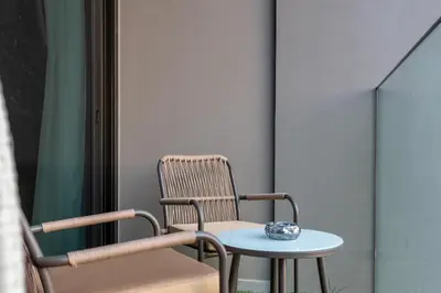 a chair and a table with a bowl on it at 2 Apt Combo Studio And 1BR Same Tower Canal View in Dubai