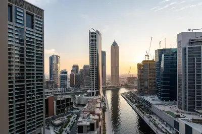 a view of a city with a river and buildings at 2 Apt Combo Studio And 1BR Same Tower Canal View in Dubai