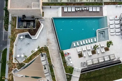 an overhead view of a swimming pool in a building at 2 Apt Combo Studio And 1BR Same Tower Canal View in Dubai