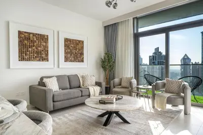 a living room with a couch and chairs and a table at Burj Khalifa Doorstep Stunning 2BR Apartment in Dubai