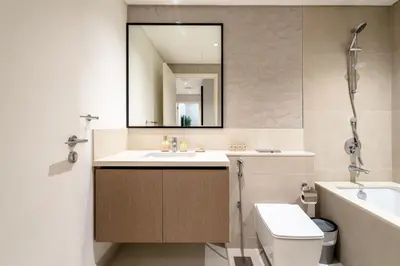 a bathroom with a sink and a mirror and a toilet at Burj Khalifa Doorstep Stunning 2BR Apartment in Dubai