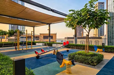 a playground with play equipment in a city at Burj Khalifa Doorstep Stunning 2BR Apartment in Dubai