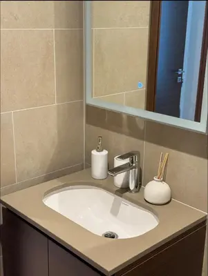 a bathroom with a sink and a mirror at Holiday heaven specious one bed room apartment near Dubai mall with burj khalifa view in Dubai