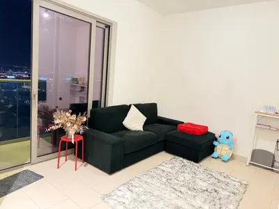a living room with a black couch and a window at Holiday heaven specious one bed room apartment near Dubai mall with burj khalifa view in Dubai