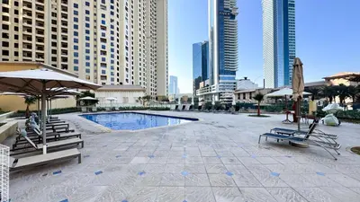a pool in the middle of a city with buildings at JBR Studio - Steps to Beach & Marina Walk - Pool & Gym in Dubai