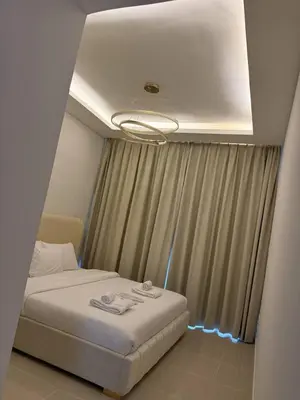 a bedroom with a white bed and a window at Aesthetic Feel with Lake View in Dubai
