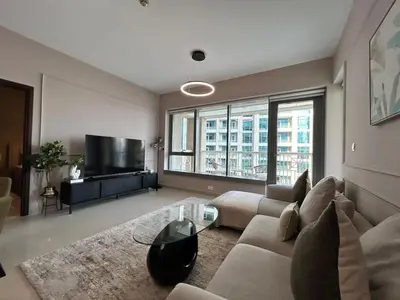 a living room with a couch and a tv at Luxurious 1Bedroom Apt in 29 Boulevard - Downtown in Dubai