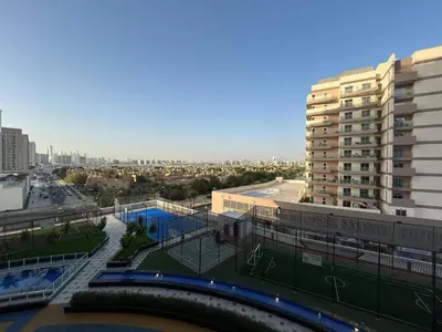 a view of a city with a building and a tennis court at Luxury two bedroom at Gemz in Dubai