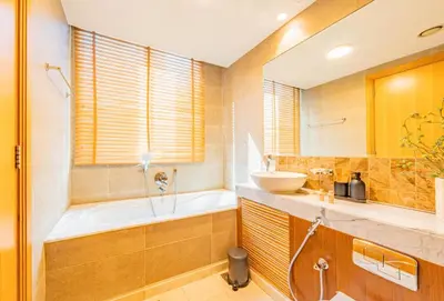 a bathroom with a tub and a sink at Stylish Two-BHK Apartment - Iris Blue, Marsa Dubai in Dubai
