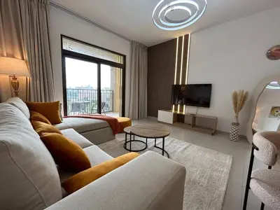 a living room with a couch and a tv at Comfortable one bed - Gym and Parking in Dubai
