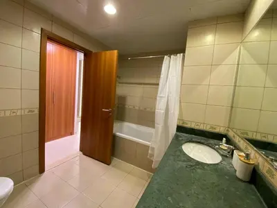 a bathroom with a sink and a shower and a toilet at Modern 2BR in Skycourt Tower A - Free Parking - Pool and Gym in Dubai