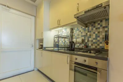 a kitchen with a sink and a stove at Stylish Studio Apt in Palm Views East PalmJumeirah in Dubai