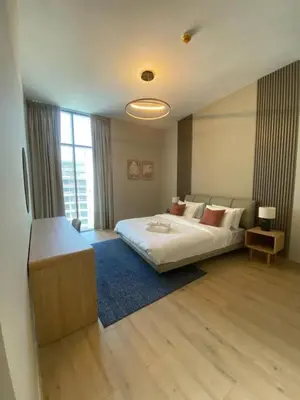 a bedroom with a bed and a large window at Two-Bedroom Apartment with Prime Metro Access in Dubai