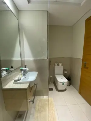 a bathroom with a sink and a toilet at Two-Bedroom Apartment with Prime Metro Access in Dubai