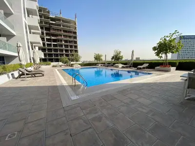 a swimming pool in the middle of a building at Two-Bedroom Apartment with Prime Metro Access in Dubai