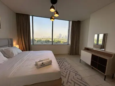 a hotel room with a bed and a large window at Luxury 2-Bedroom Apartment in DIFC in Dubai