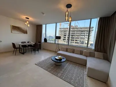 a large living room with a couch and a table at Luxury 2-Bedroom Apartment in DIFC in Dubai