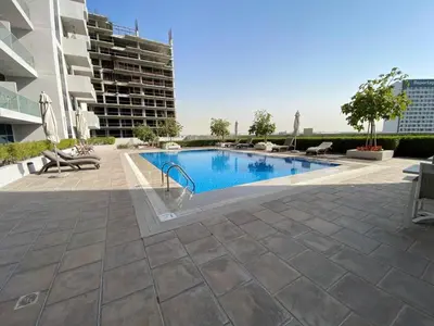 a swimming pool in the middle of a building at Furnished studio apartment next to metro in Dubai