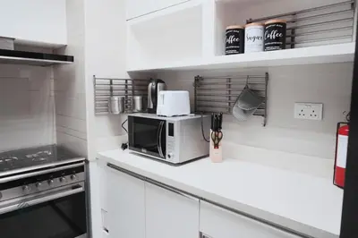 a kitchen with a microwave on a counter at Luxurious 3 BR Apt in Park Gate Residences in Dubai