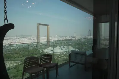 a room with chairs and a view of a city at Luxurious 3 BR Apt in Park Gate Residences in Dubai