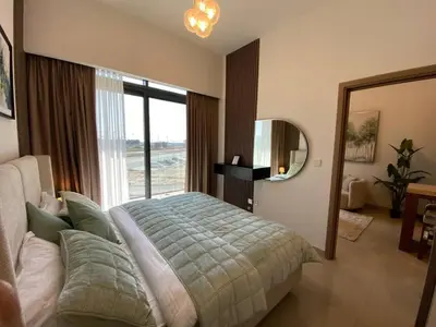 a bedroom with a bed and a large window at Cozy 1 Bedroom Apartment near Downtown in Dubai