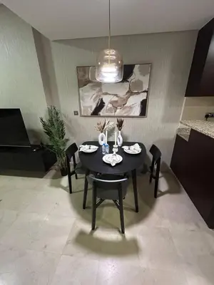 a dining room with a black table and chairs at Elegant Studio in Difc - Skyline Views, Pool, Gym in Dubai