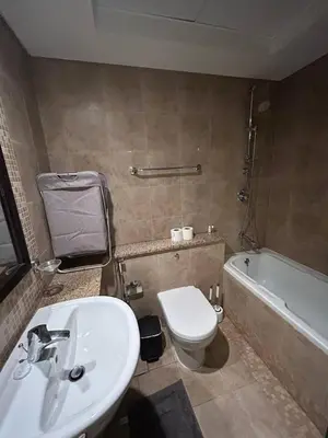 a bathroom with a sink and a toilet and a tub at Elegant Studio in Difc - Skyline Views, Pool, Gym in Dubai